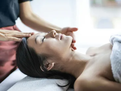 Relaxing head and face massage wrapped in a warm towel during a Forest Spa head spa session