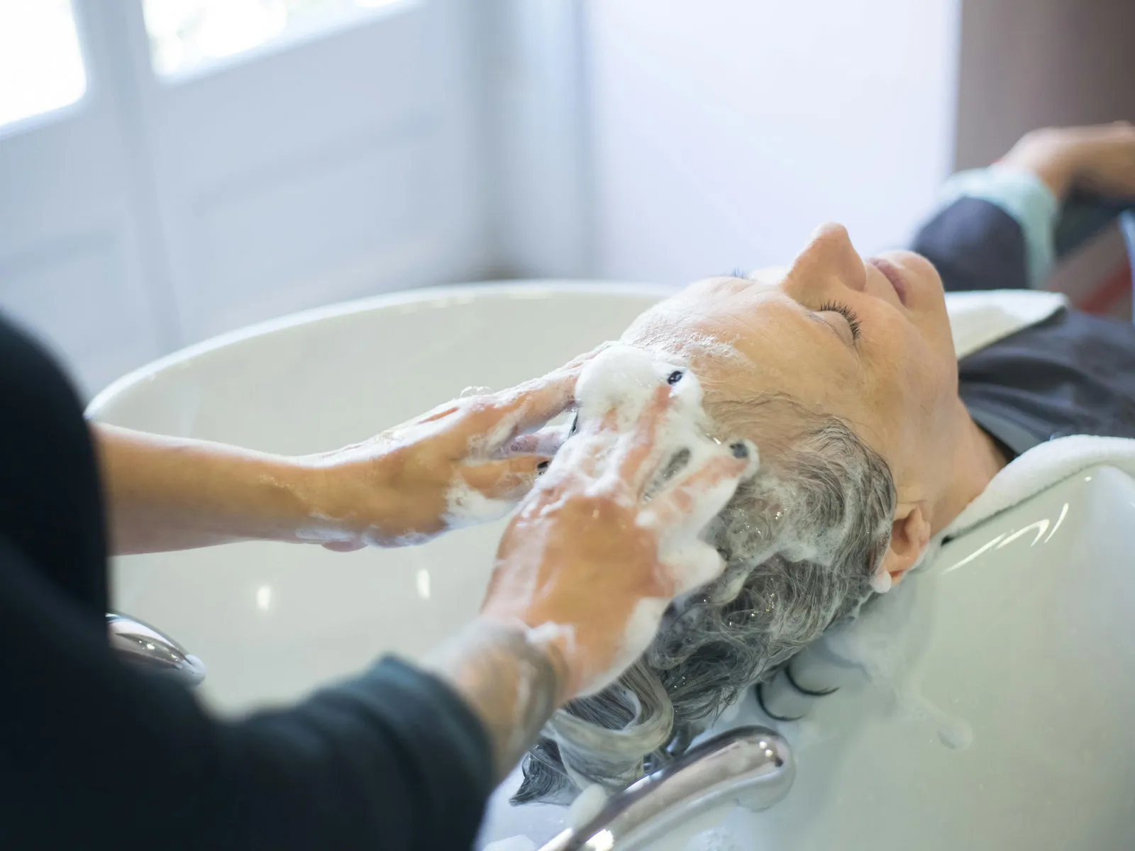 Nourishing scalp cleanse and lather in the head spa basin