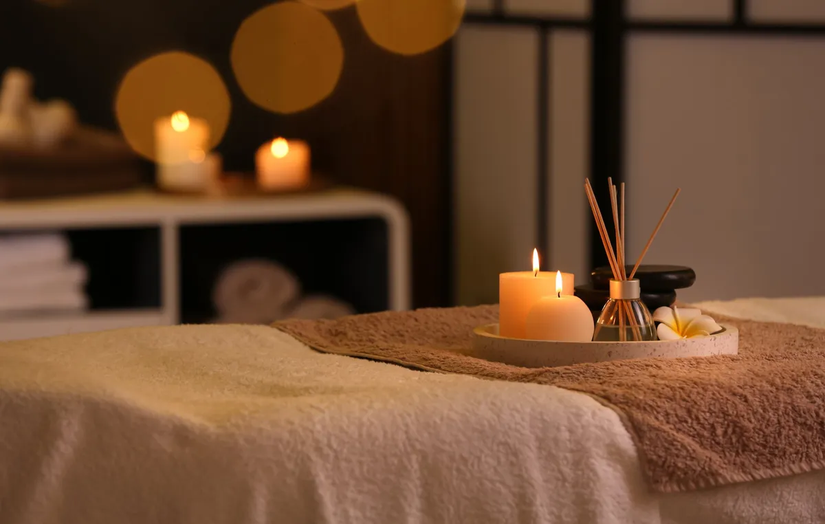 Candlelit massage room at Forest Spa in Poway with warm candles and an essential oil diffuser